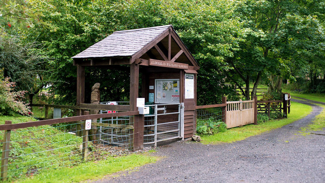 Timbered porch entrance to wetland garden at Aldouran Glen, near Stranraer, Scotland