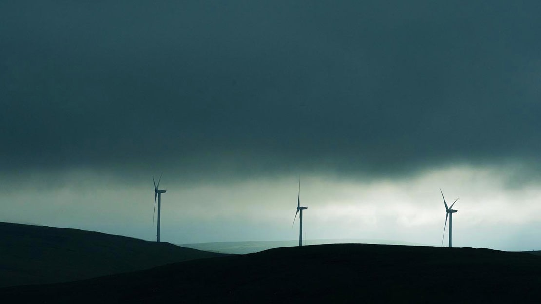 Three wind turbines in silhouette, Glen Sherup