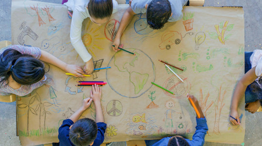 Children making a 'save the earth' poster