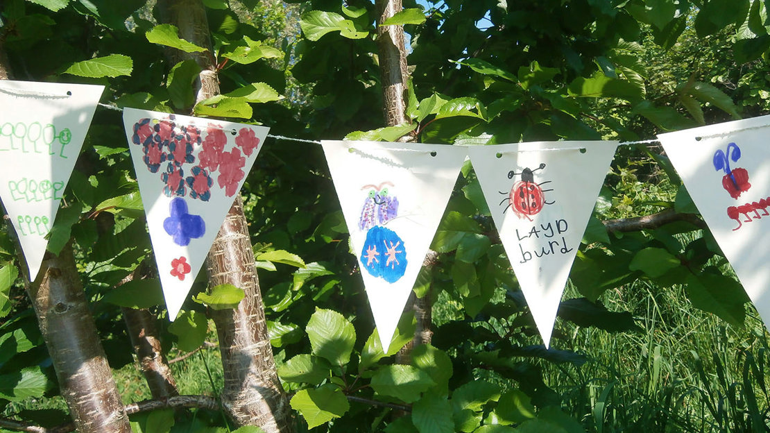 Bunting made by children, decorating trees