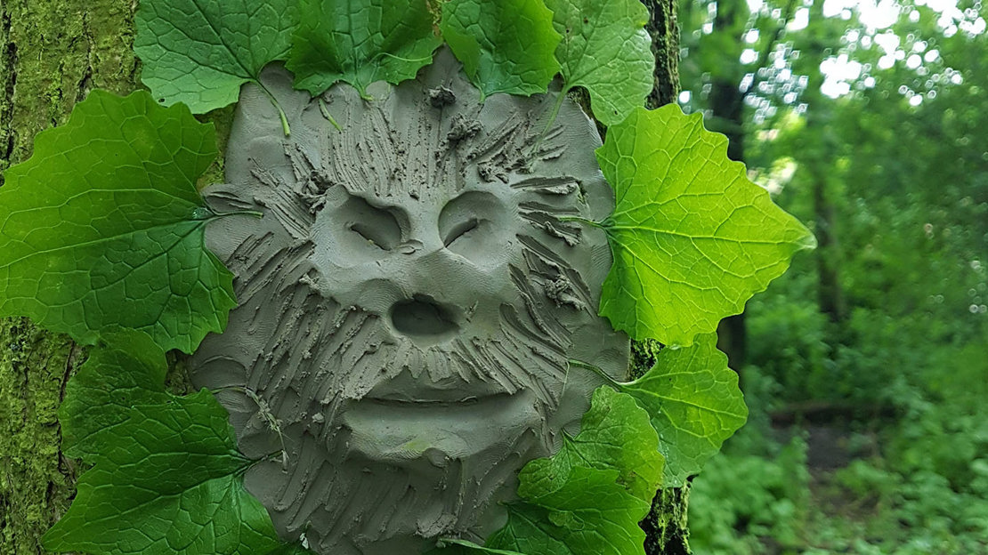 Clay face on a tree trunk