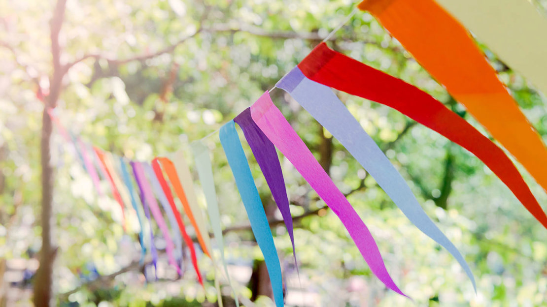 Colourful bunting tied between trees