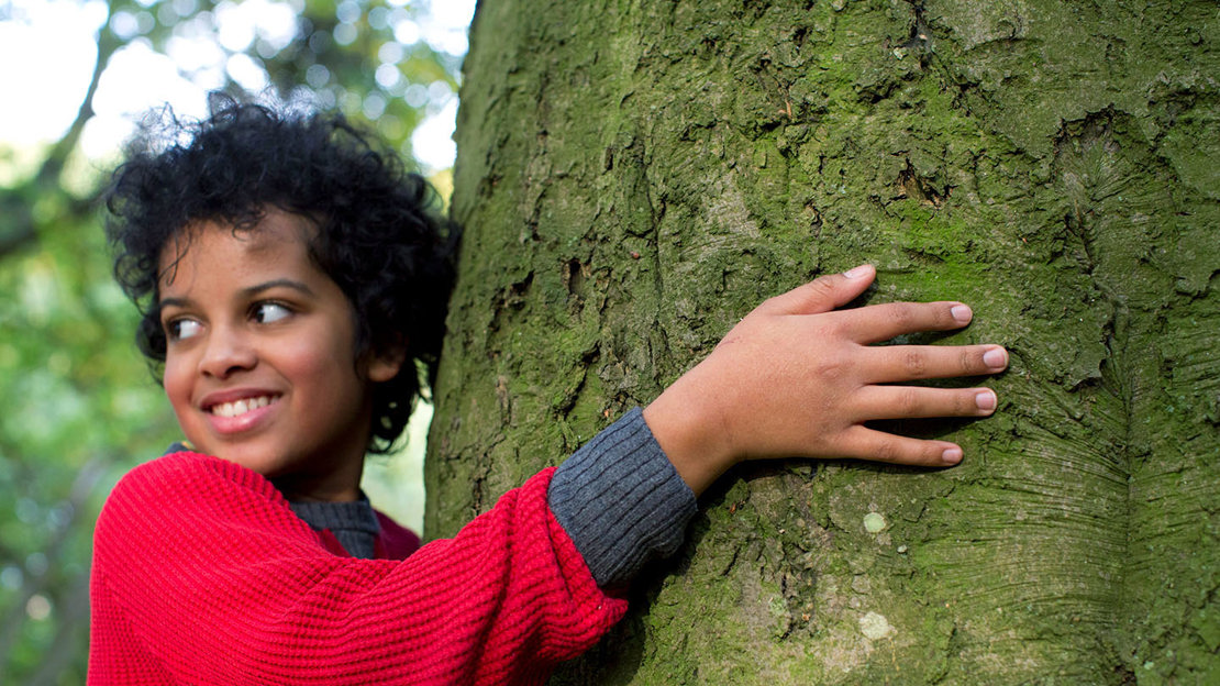Boy hugging a tree Boy hugging a tree