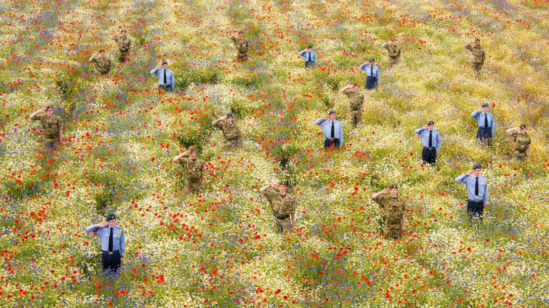 Cadets standing to attention among poppies at Heartwood Forest
