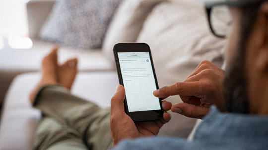 Man scrolling through his phone