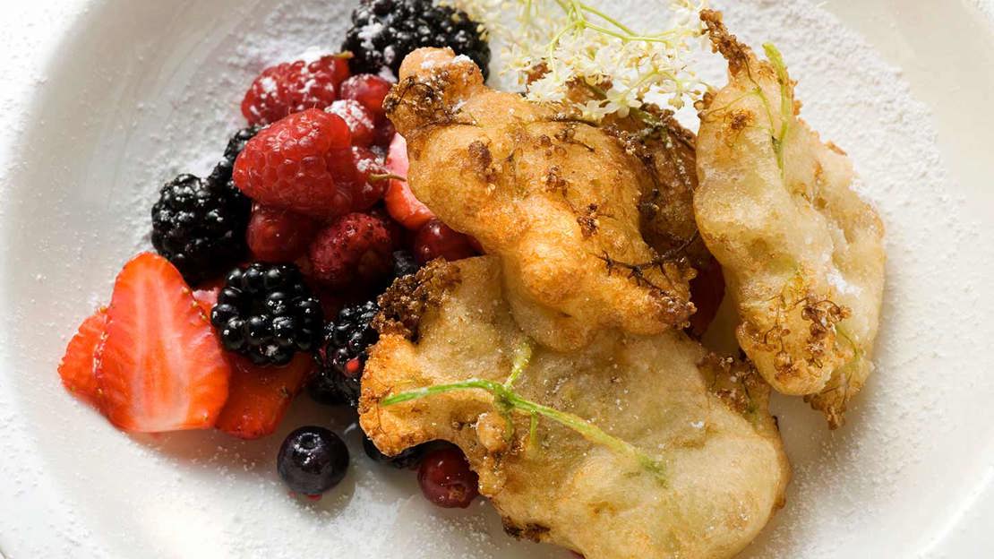 Elderflower fritters desert with  summer fruits.