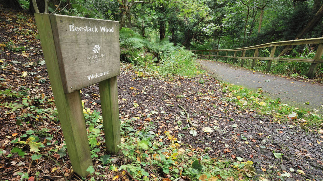 Welcome sign at Beeslack Wood