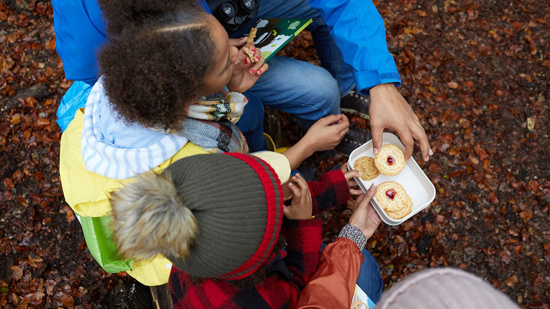 Family sharing biscuits from tin