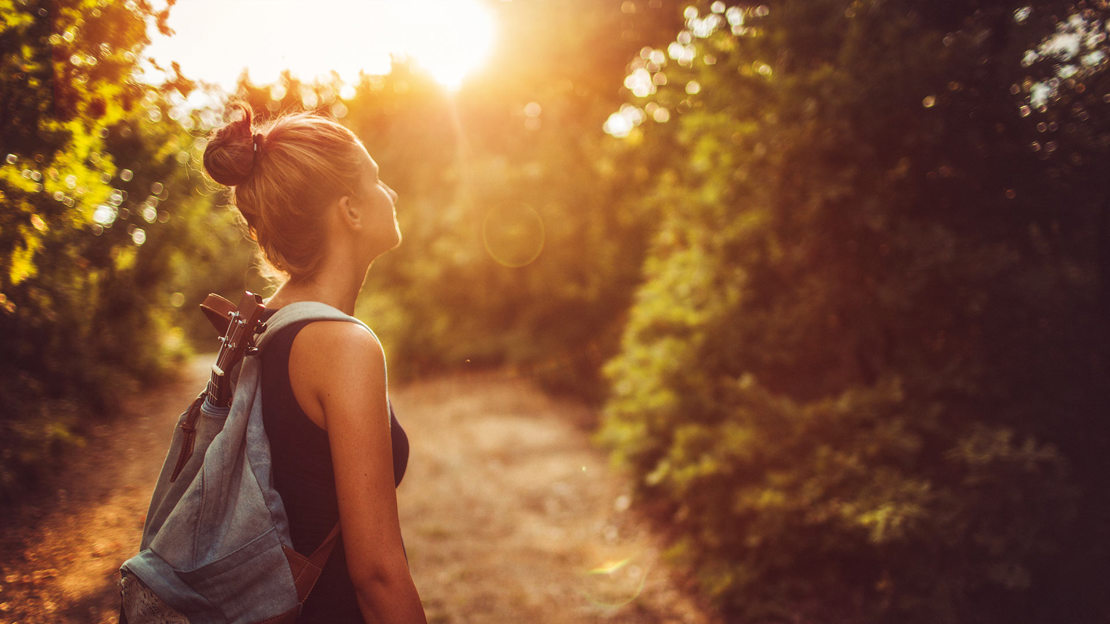 Young woman wandering around woodland