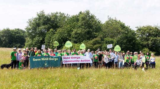 Group of people with banners and placards posing for photo at Nidd Gorge