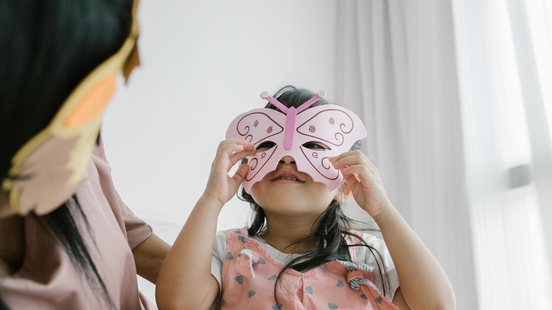 Child wearing butterfly mask