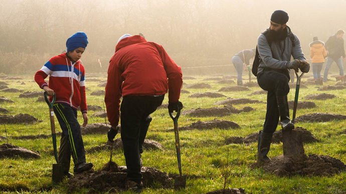 Sikh men planting trees on a community day at Young People's Forest, Mead