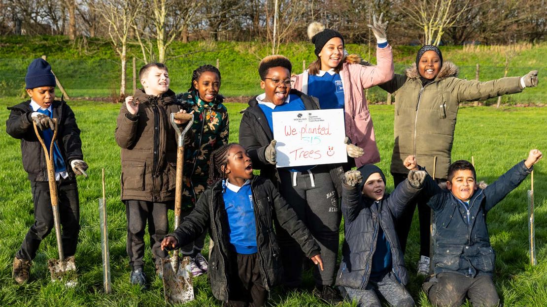 Pupils at Buswell Lodge Primary School celebrating planting hundreds of trees