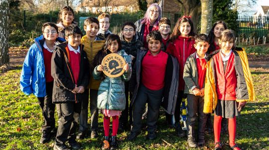 Primary school pupils with their Green Tree Schools Award gold plaque