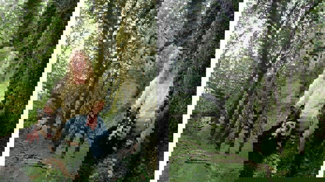 Outdoor profile shot of Elizabeth Pryor with a dog and a close up of an ancient tree