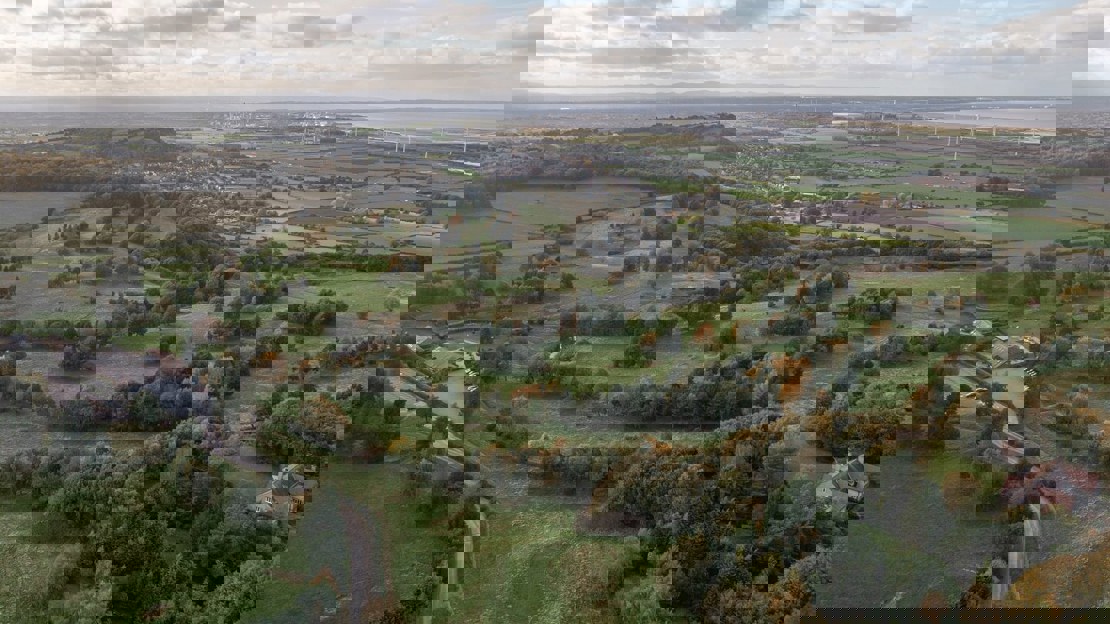Aerial view of golf course interspersed with trees