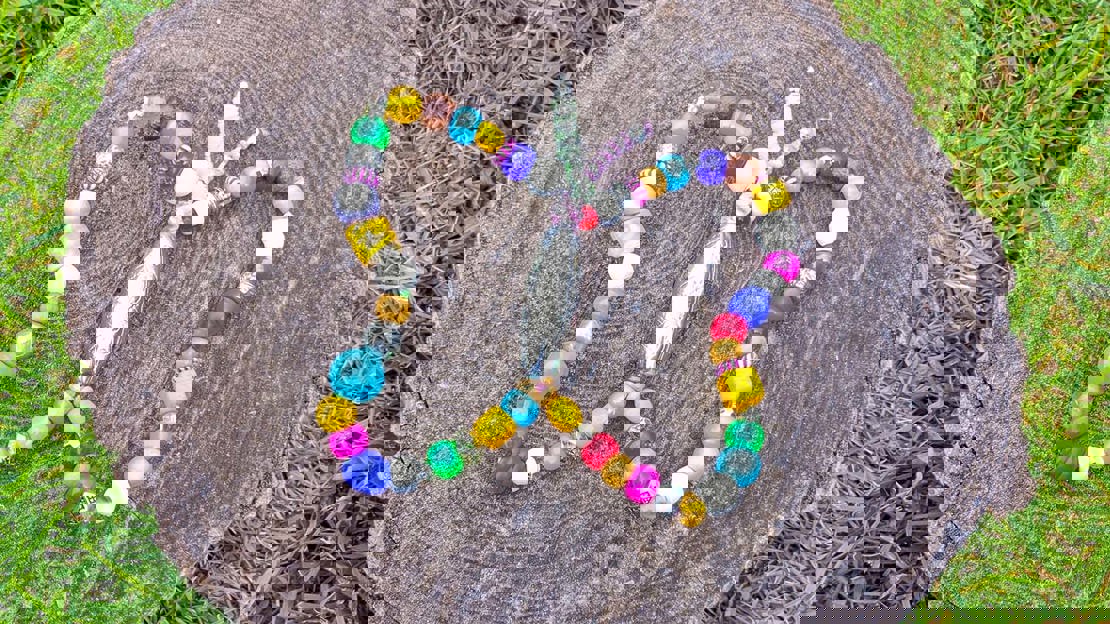 Butterfly craft made from beads threaded onto a pipe cleaner and bent into shape