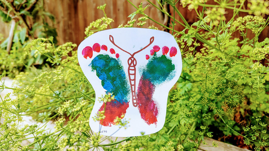 Colourful butterfly painting with the wings made from a child's footprints