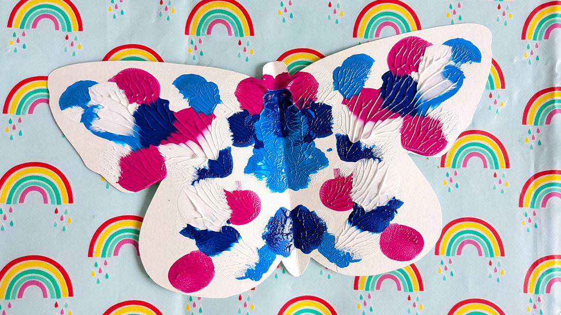 Vibrant butterfly symmetry painting in blues and purples