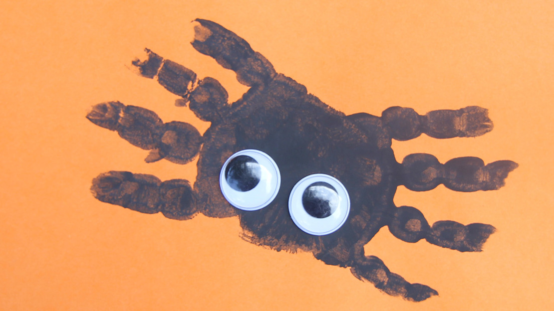 A spider painting made from child handprints
