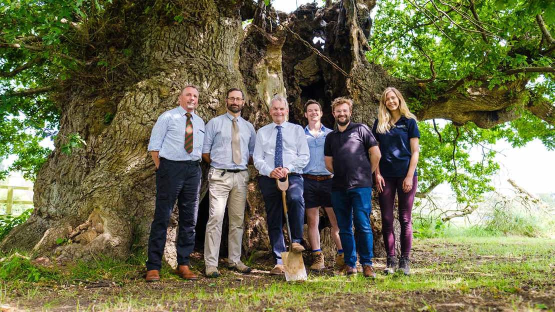 LincWoods project partners posing to camera in front of large oak tree.