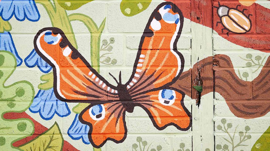 Butterfly painted on wall mural.