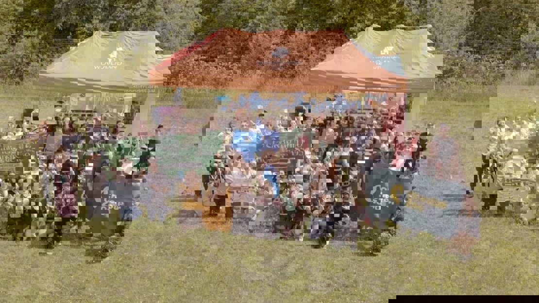 Group of young people with campaign banners in a grassy field